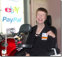 Glenda Watson Hyatt proudly holding up her BlogWorld 09 speaker's badge