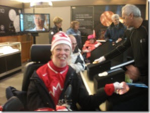 Glenda touching a 2010 Paralympic bronze medal