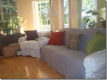 Couch freshly made with neww, brightly coloured pillows