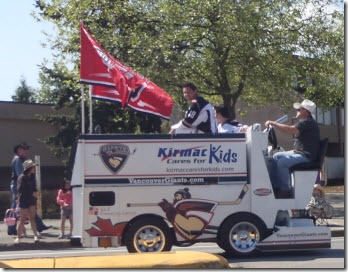 A zamboni with the driver wearing a cowboy hats